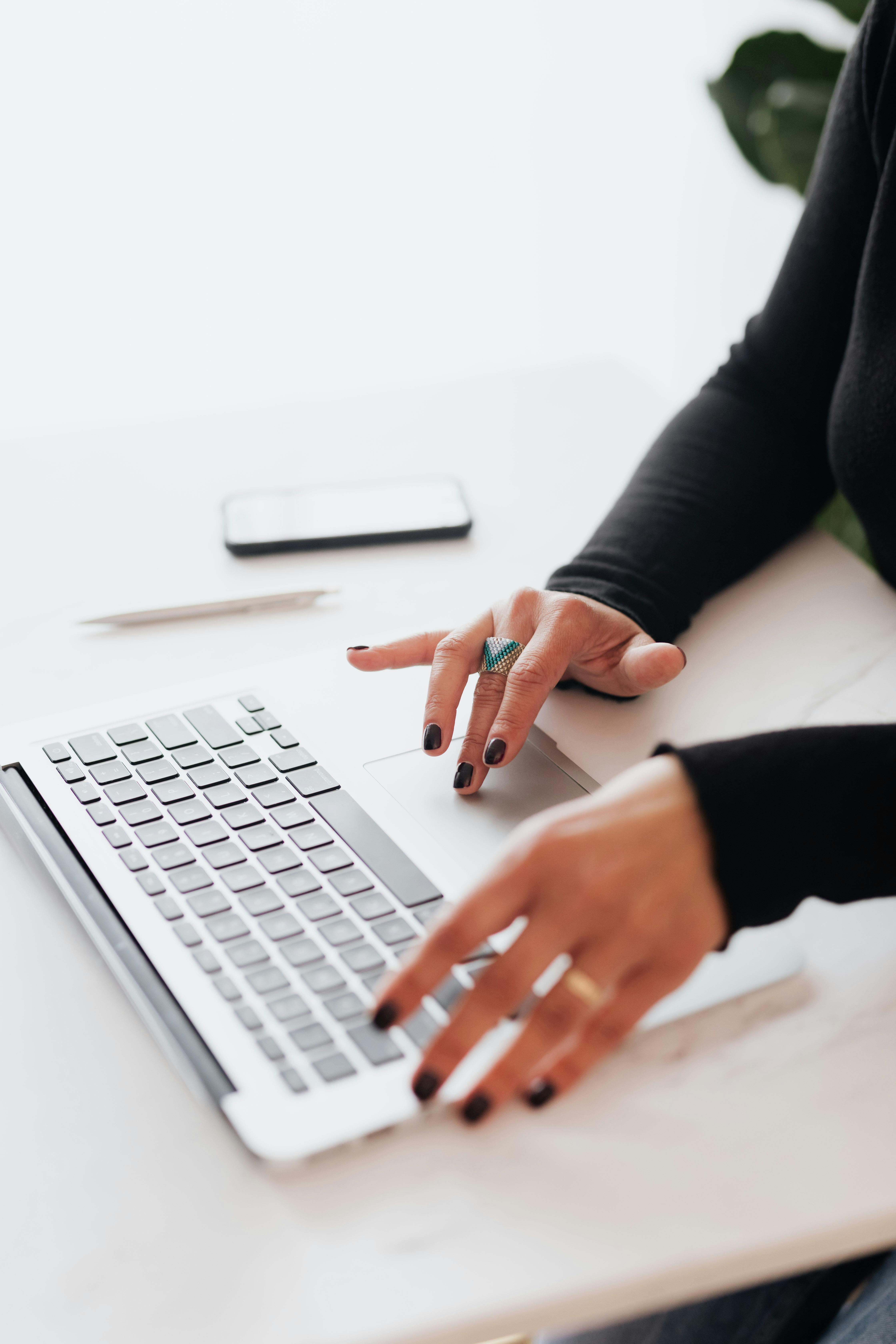 women typing on laptop